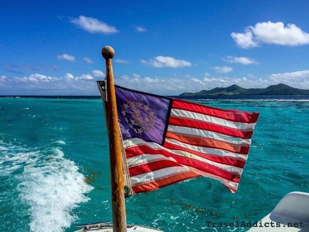 U.S. marine flag with Buck Island Reef National Monument, St. Croix, U.S. Virgin Islands in the background.